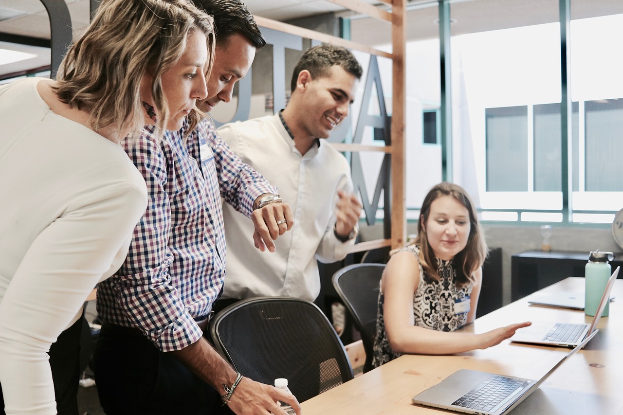 Four persons in a business meeting.