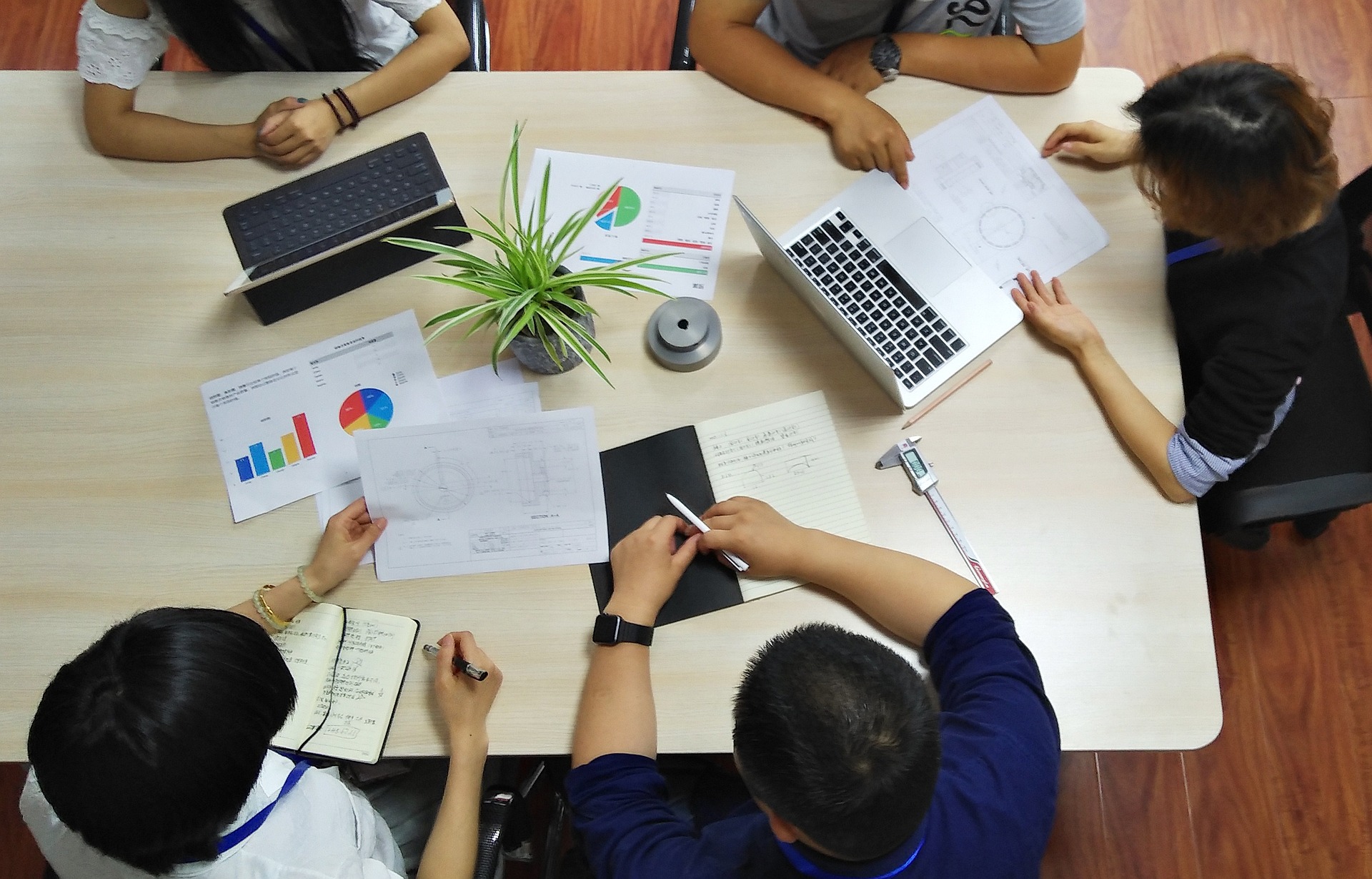 Four persons in a business meeting.